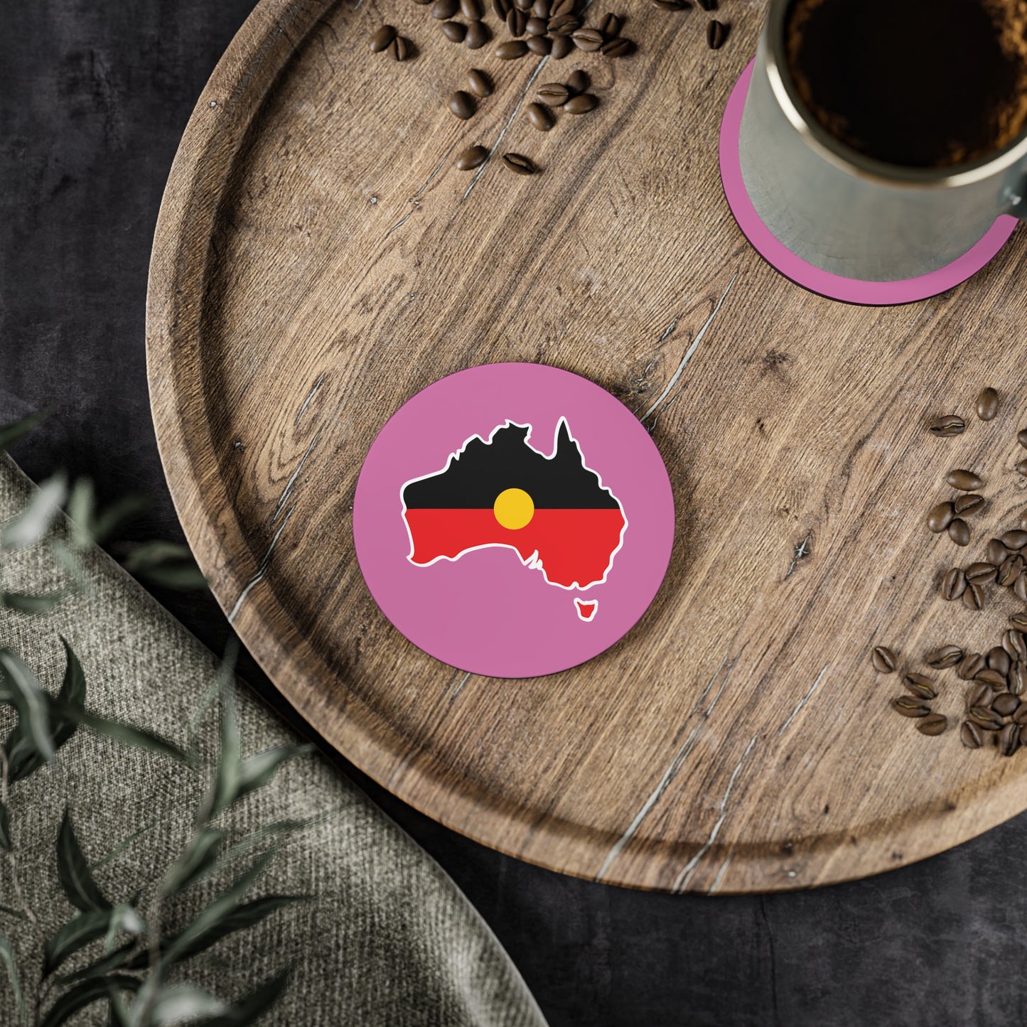 Pink circular Aboriginal coaster, Australia design, in dining setting