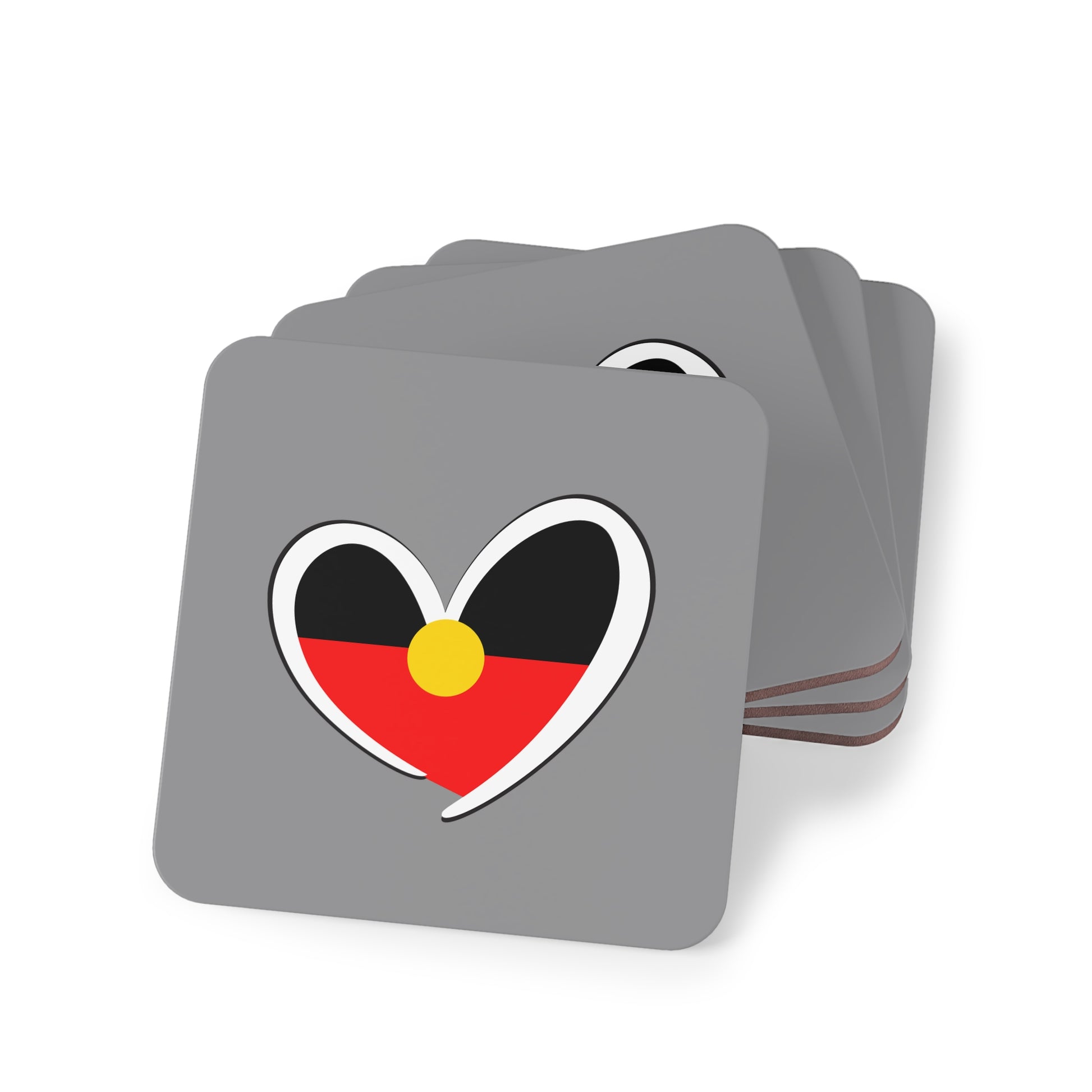 Stacked square grey coasters with Aboriginal heart design, perfect for cultural home decor.